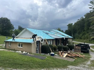 Veteran Roofing Systems crew repairing storm damaged shingles